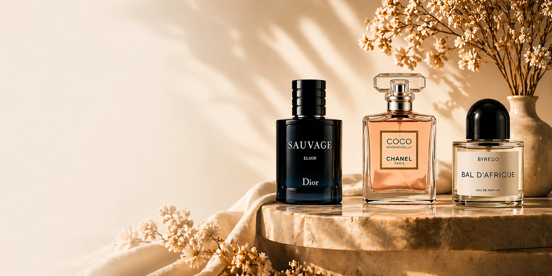 Dior Sauvage, Chanel Coco and Byredo on a sunlit stone plinth
